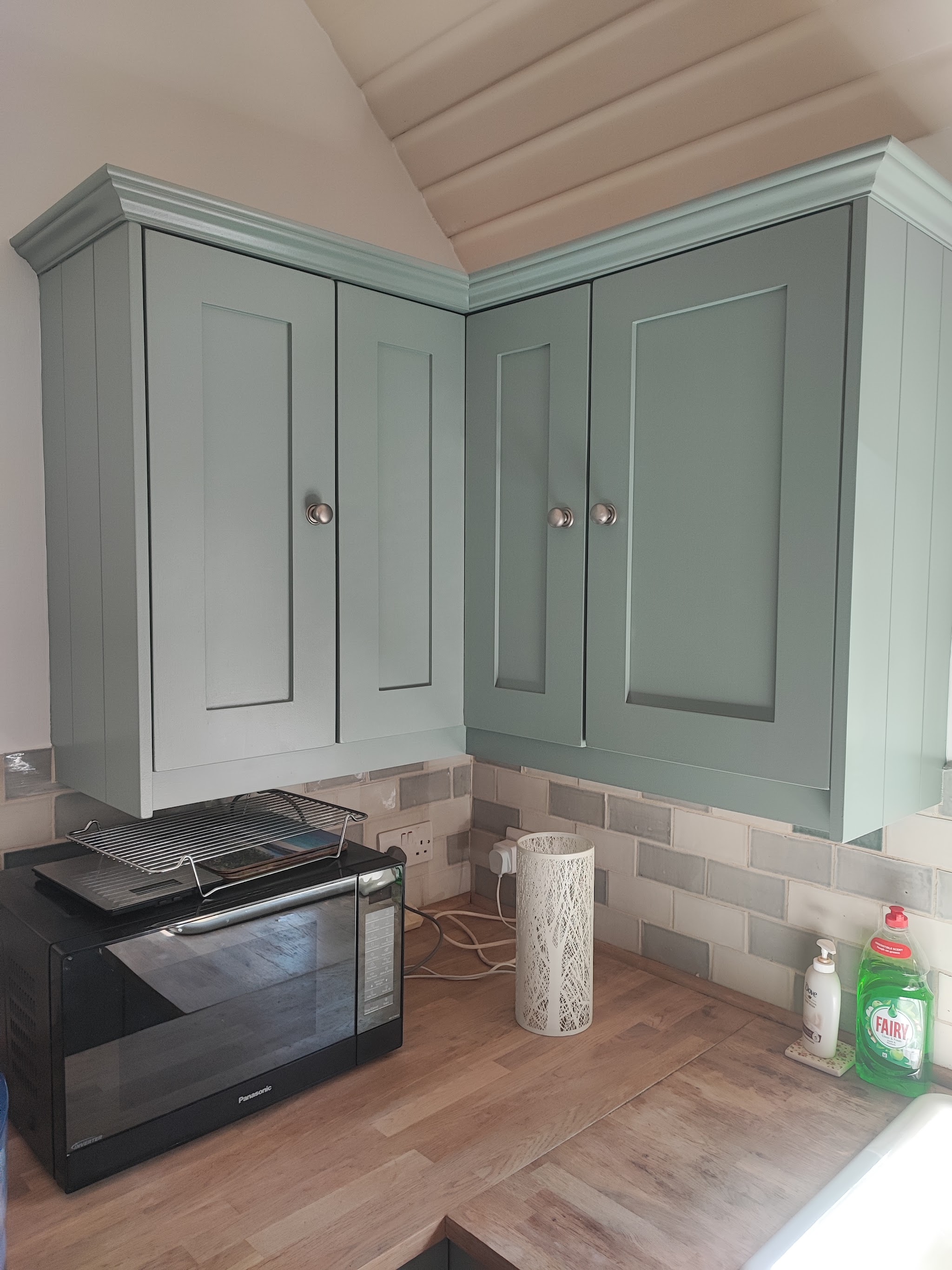 Wall cabinets hand-painted in soft sage green