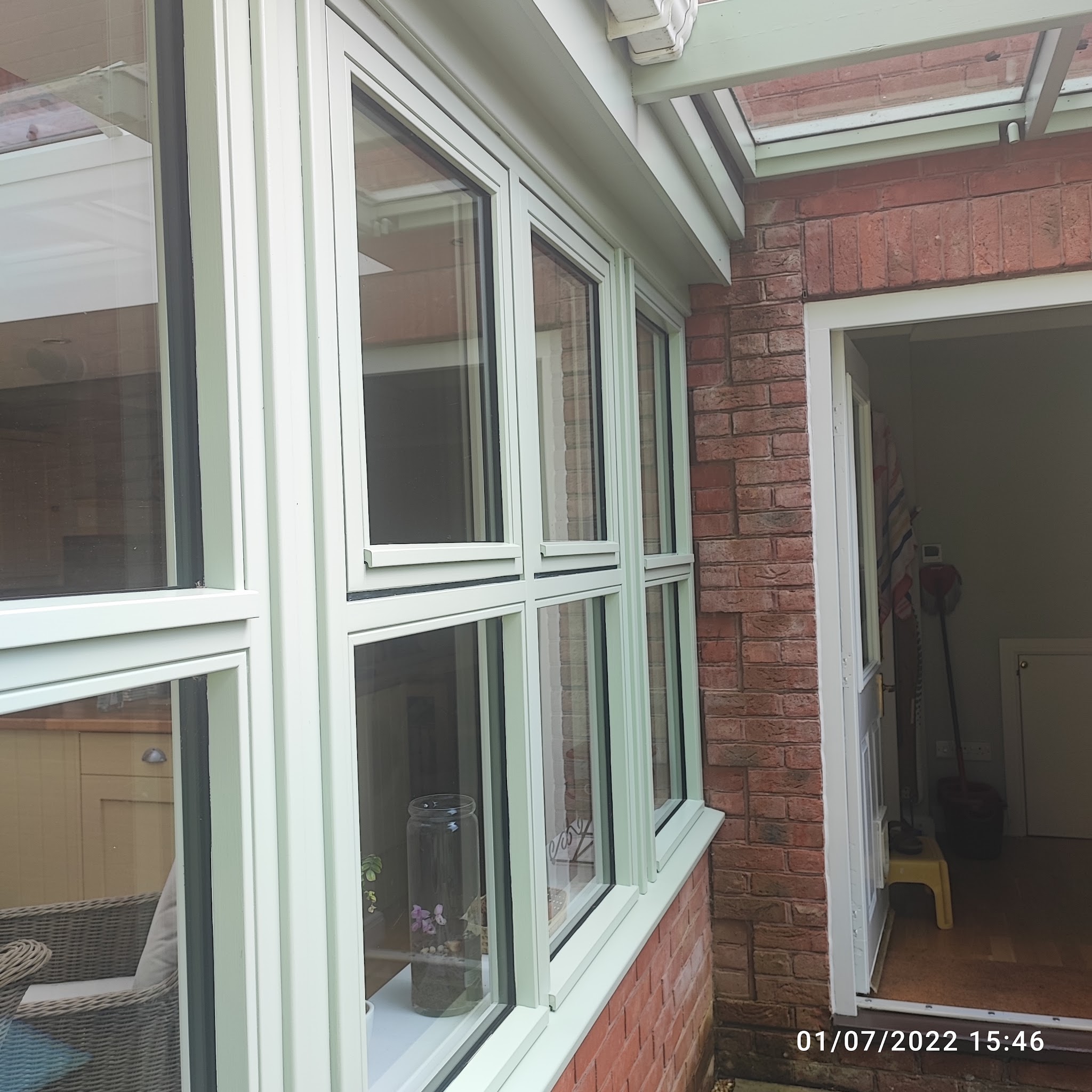 Sage green painted timber windows and door frame