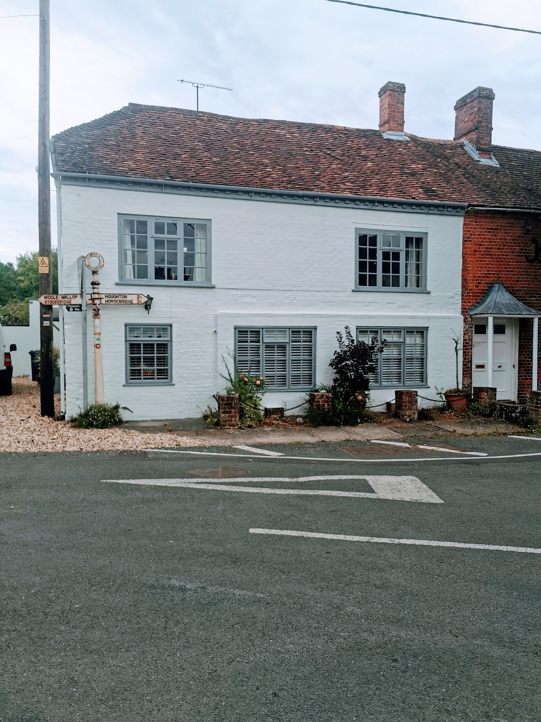 White painted village cottage with grey window frames